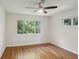 Bright bedroom with hardwood floors, ceiling fan, and large windows overlooking the backyard at 3282 Leslie Court Northeast Ne Ct, Atlanta, GA 30345