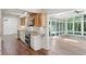 Kitchen open to sunroom with walls of windows offering a view of the tree-lined backyard at 3282 Leslie Court Northeast Ne Ct, Atlanta, GA 30345