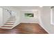 Bright living room with hardwood floors, view of staircase and a modern light fixture at 3282 Leslie Court Northeast Ne Ct, Atlanta, GA 30345