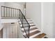 Interior staircase with metal railing, featuring hardwood treads and a neutral color scheme at 3282 Leslie Court Northeast Ne Ct, Atlanta, GA 30345