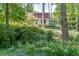 Picturesque home with a lush garden, mature trees, and inviting landscaping at 3219 Parkridge Crescent, Chamblee, GA 30341