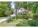 Charming cottage-style home with beautiful landscaping, a stone walkway and driveway through lush greenery at 3219 Parkridge Crescent, Chamblee, GA 30341