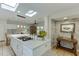 Open kitchen featuring a large island cooktop, skylights, and eat-in dining area at 3219 Parkridge Crescent, Chamblee, GA 30341