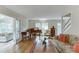 Bright living room with hardwood floors, piano, view of sunroom, neutral walls, and classic furniture at 3219 Parkridge Crescent, Chamblee, GA 30341
