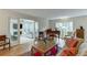 Open living room with hardwood floors, piano, large windows and glass paneled doors to an additional sun room at 3219 Parkridge Crescent, Chamblee, GA 30341