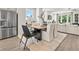 Open concept kitchen and dining area with stainless steel appliances and modern furniture at 402 Nix Ln, Lawrenceville, GA 30046