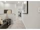 Hallway seating area enhanced by neutral tones and modern art creates an inviting transition space at 402 Nix Ln, Lawrenceville, GA 30046