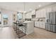 Modern kitchen features white cabinets, stainless steel appliances, and a spacious island with barstool seating at 402 Nix Ln, Lawrenceville, GA 30046