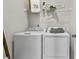 Efficient laundry room featuring a washer and dryer set, with shelving and decorative accents at 402 Nix Ln, Lawrenceville, GA 30046