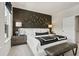 Cozy bedroom featuring a stylish accent wall, comfortable king bed, and elegant bedside lamps at 402 Nix Ln, Lawrenceville, GA 30046
