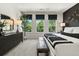 A relaxing main bedroom with a black accent wall, a dresser, and lots of natural light from the three windows at 402 Nix Ln, Lawrenceville, GA 30046