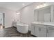 Bright bathroom featuring double vanities, soaking tub, large mirrors, and stylish tile flooring at 775 Hadley Ne Ln, Marietta, GA 30068
