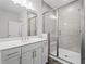 Bathroom features glass enclosed shower with white tiles and white cabinets with modern hardware at 775 Hadley Ne Ln, Marietta, GA 30068