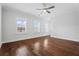 A bedroom with hardwood floors, crown molding, three windows and a ceiling fan at 775 Hadley Ne Ln, Marietta, GA 30068