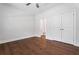 Bright bedroom features hardwood floors, a ceiling fan, closet, and adjacent bathroom at 775 Hadley Ne Ln, Marietta, GA 30068