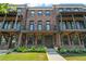 Elegant brick townhome with a covered porch, balcony, and manicured landscaping at 775 Hadley Ne Ln, Marietta, GA 30068