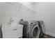 Laundry room with front-load washer and dryer, utility sink, and wire rack at 775 Hadley Ne Ln, Marietta, GA 30068