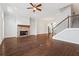 Open floor plan featuring fireplace, hardwood floors, staircase, and kitchen view at 775 Hadley Ne Ln, Marietta, GA 30068