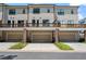 Rear view of townhomes featuring decks and drive-under garages at 775 Hadley Ne Ln, Marietta, GA 30068