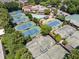 Aerial view showcases multiple tennis courts, a swimming pool, and clubhouse amenities amidst lush greenery at 775 Hadley Ne Ln, Marietta, GA 30068