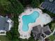 Aerial view of the large community pool and surrounding seating areas with lounge chairs and tables at 200 Ennisbrook Se Dr, Smyrna, GA 30082
