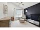 Bright Bedroom with a comfy chair, modern ceiling fan, and black accent wall at 200 Ennisbrook Se Dr, Smyrna, GA 30082