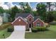 Charming two-story home with a brick facade, well-manicured lawn, and a two-car garage at 200 Ennisbrook Se Dr, Smyrna, GA 30082