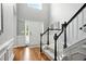 Bright foyer with hardwood floors, staircase, and wainscoting at 200 Ennisbrook Se Dr, Smyrna, GA 30082