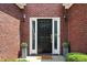 Inviting front entrance with black door, sidelights, and decorative potted plants at 200 Ennisbrook Se Dr, Smyrna, GA 30082