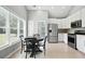 Bright eat-in kitchen with stainless appliances, white cabinetry, and natural light from large windows at 200 Ennisbrook Se Dr, Smyrna, GA 30082