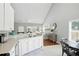 Bright kitchen with white cabinets, modern appliances, and breakfast bar overlooking the living area at 200 Ennisbrook Se Dr, Smyrna, GA 30082