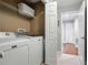 Laundry room with side-by-side washer and dryer and a view to the hallway at 200 Ennisbrook Se Dr, Smyrna, GA 30082