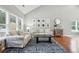 Comfortable living room with large windows and hardwood floors and neutral decor at 200 Ennisbrook Se Dr, Smyrna, GA 30082
