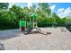 The community playground features a swing set and climbing equipment surrounded by mature trees at 200 Ennisbrook Se Dr, Smyrna, GA 30082
