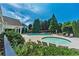 Large community pool and outdoor hot tub surrounded by lush landscaping and comfortable lounge chairs at 200 Ennisbrook Se Dr, Smyrna, GA 30082