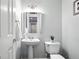 Powder room featuring a pedestal sink and toilet with white fixtures at 200 Ennisbrook Se Dr, Smyrna, GA 30082