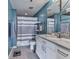 Well-lit bathroom featuring a granite countertop and white and grey striped shower curtain at 361 17Th St # 1121, Atlanta, GA 30363