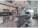 Modern kitchen with stainless steel appliances, light cabinets, bar seating, and industrial style lighting at 361 17Th St # 1121, Atlanta, GA 30363