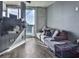 Cozy living room featuring hardwood floors, balcony access, and city views at 361 17Th St # 1121, Atlanta, GA 30363