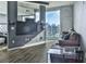 Living room featuring wood floors, large windows with city views, and modern decor at 361 17Th St # 1121, Atlanta, GA 30363