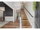 Inviting foyer with hardwood floors, a staircase with a black railing, and a barn door detail at 429 Tannenhill Pl, Sugar Hill, GA 30518