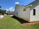 View of the backyard from the corner shows level lot and the home's white siding at 341 Brooke View Trail, Canton, GA 30115