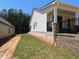 A view of the side of the home shows retaining wall, and white siding at 341 Brooke View Trail, Canton, GA 30115