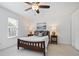 Bedroom featuring a ceiling fan and end tables with lamps at 5 Palace Green Place Nw, Atlanta, GA 30318