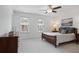 Bright bedroom with two windows, ceiling fan, and a comfortable bed and end tables at 5 Palace Green Place Nw, Atlanta, GA 30318