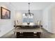 Dining room features a chandelier and custom table with bench seating at 5 Palace Green Place Nw, Atlanta, GA 30318