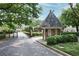 Community entrance with a gatehouse and well-maintained landscaping at 5 Palace Green Place Nw, Atlanta, GA 30318