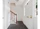 Entryway with gray tile floor, stairway with wood railing, and white front door with gold hardware at 5 Palace Green Place Nw, Atlanta, GA 30318