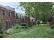 Exterior view of brick townhomes with green spaces and mature trees at 5 Palace Green Place Nw, Atlanta, GA 30318