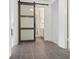 Hallway features a sliding barn door and tile flooring at 5 Palace Green Place Nw, Atlanta, GA 30318